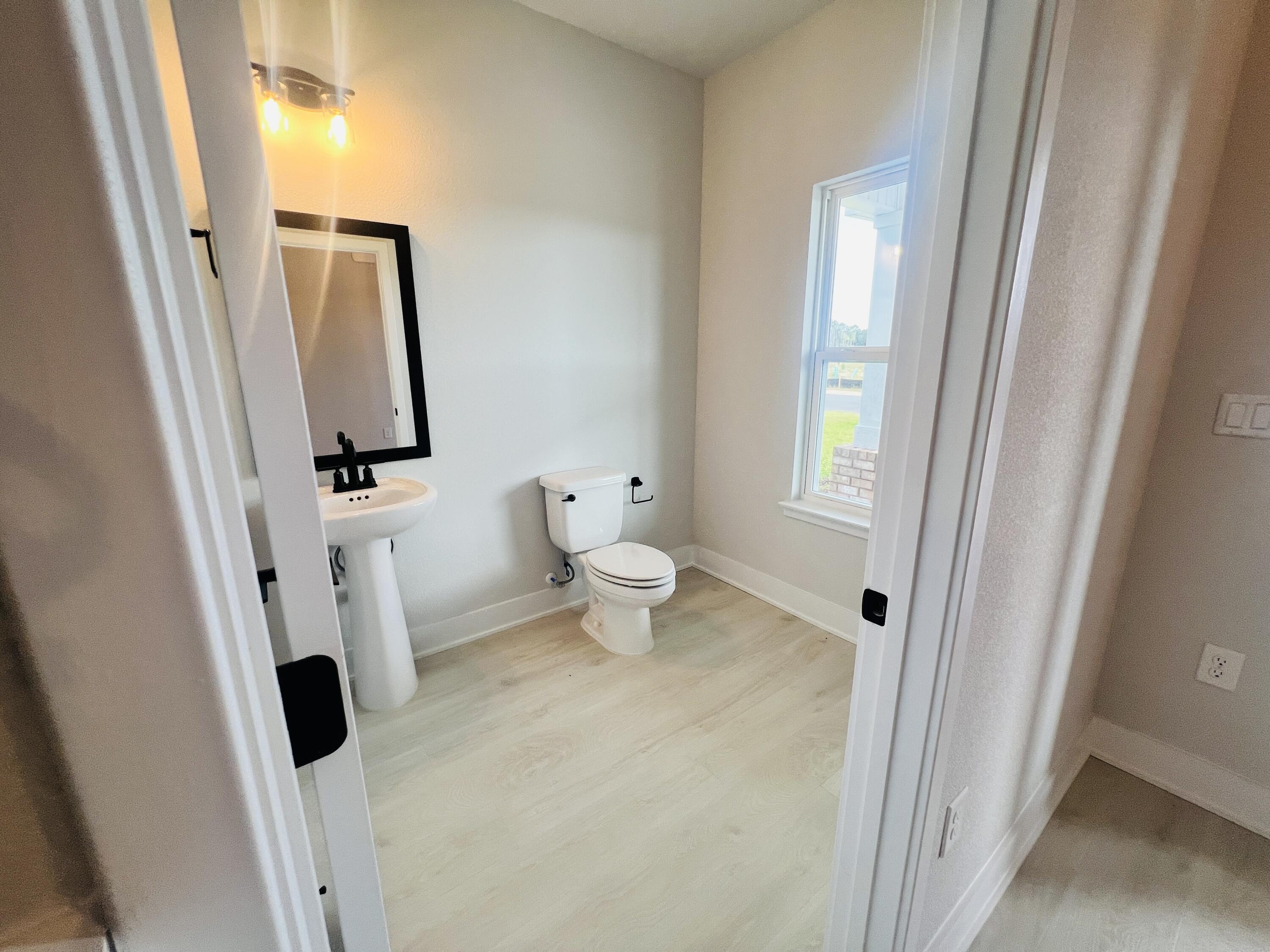 5291 Hidden Pines Circle Milton, FL 32583 - Photo 6 of 21 a bathroom with a toilet and a sink