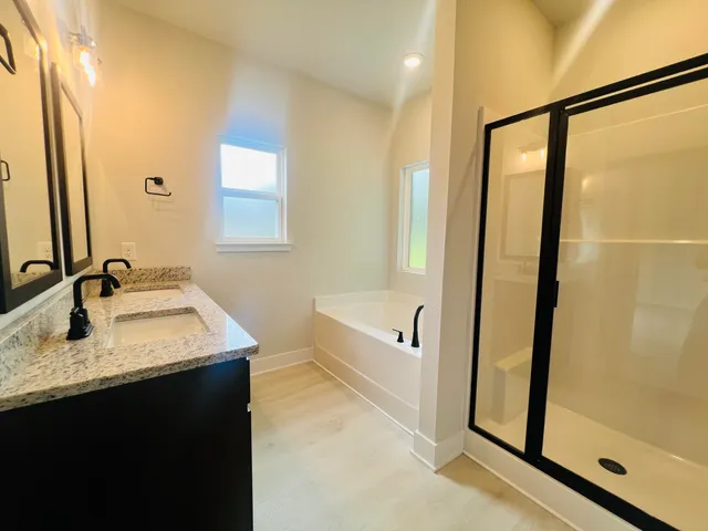 a bathroom with a tub sink and mirror