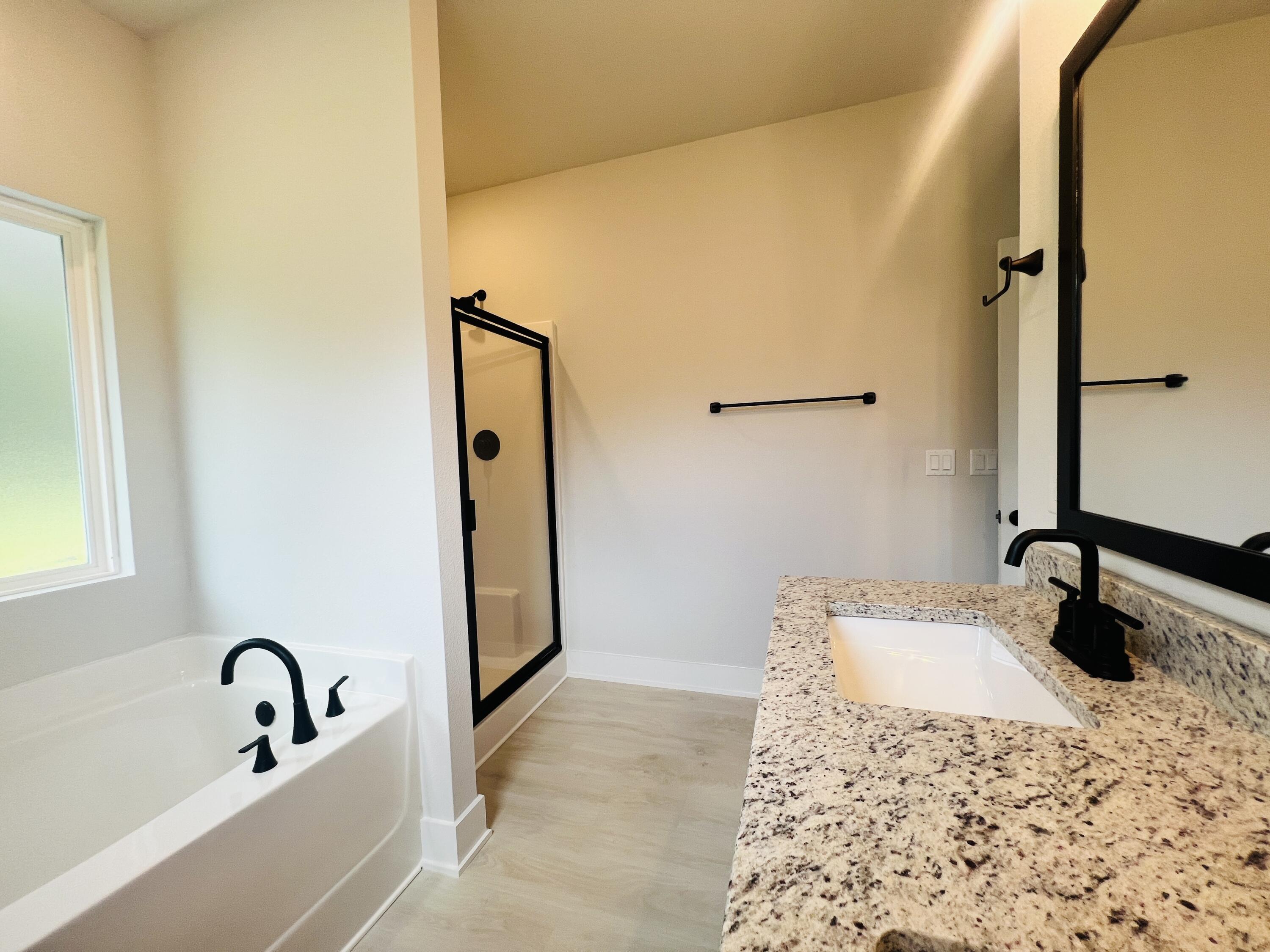 5291 Hidden Pines Circle Milton, FL 32583 - Photo 10 of 21 a bathroom with a tub sink and mirror