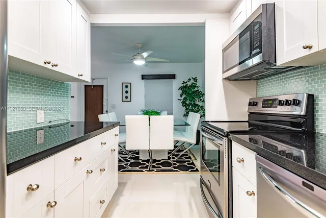 a kitchen with stainless steel appliances granite countertop a stove and a sink