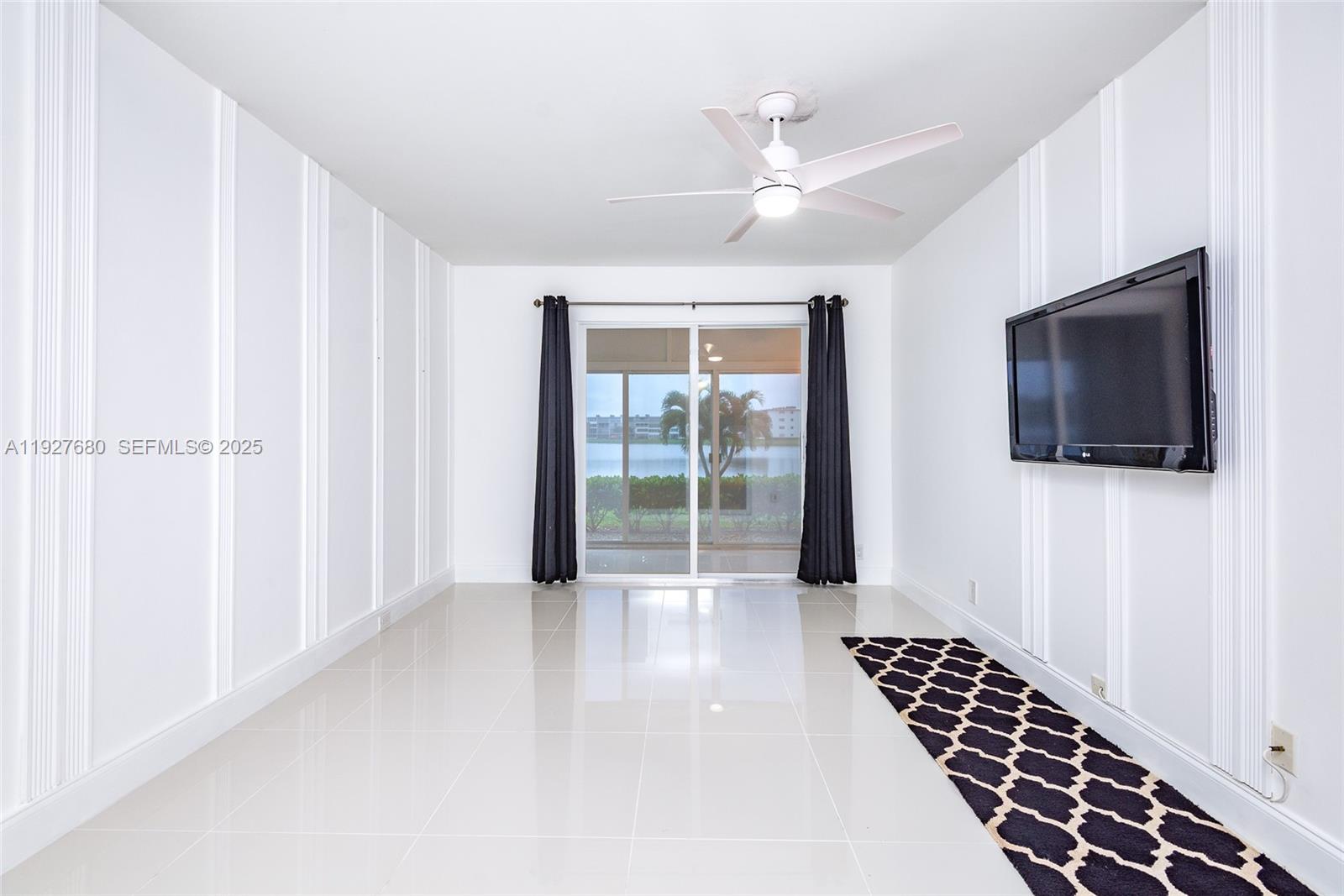 1061 Exeter, Unit 1061D Boca Raton, FL 33434 - Photo 14 of 32 a view of a livingroom with a flat screen tv