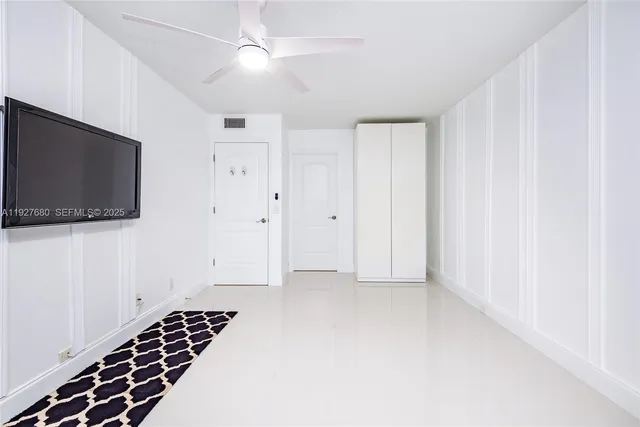a view of an empty room with a flat screen tv