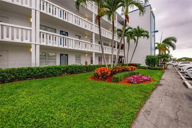 a view of a house with a garden and pathway