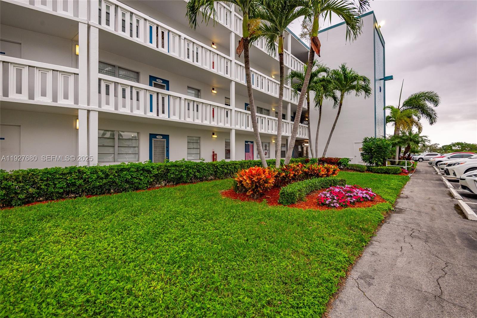 1061 Exeter, Unit 1061D Boca Raton, FL 33434 - Photo 2 of 32 a view of a house with a garden and pathway