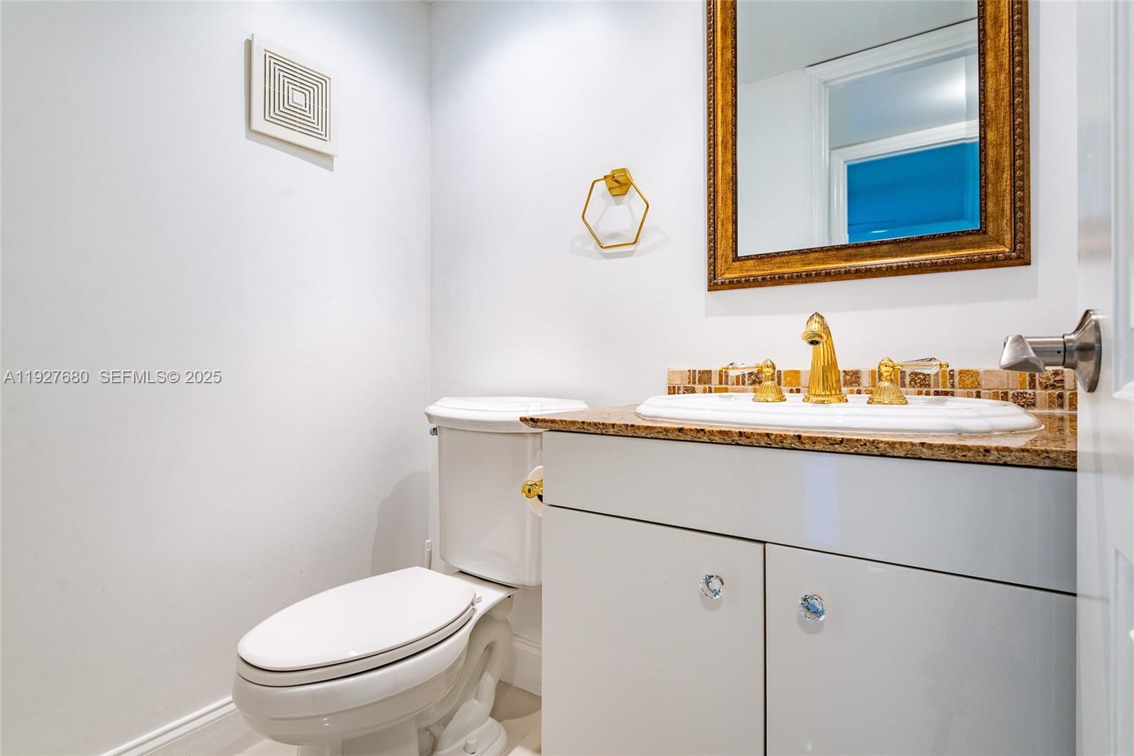 1061 Exeter, Unit 1061D Boca Raton, FL 33434 - Photo 21 of 32 a bathroom with a sink and a toilet