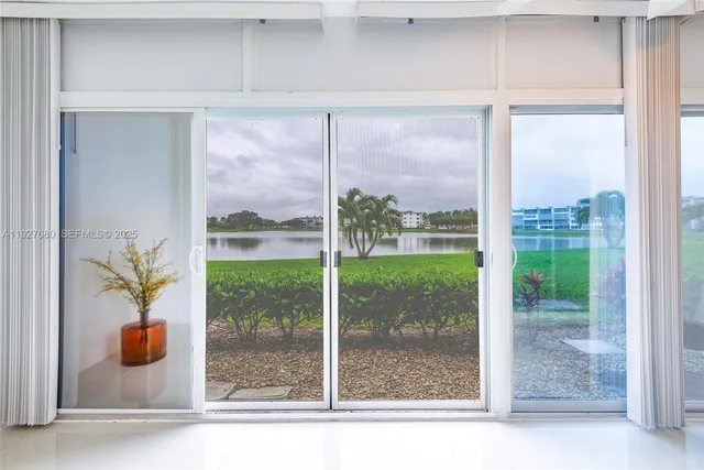 a view of a room that has a sliding door and a porch
