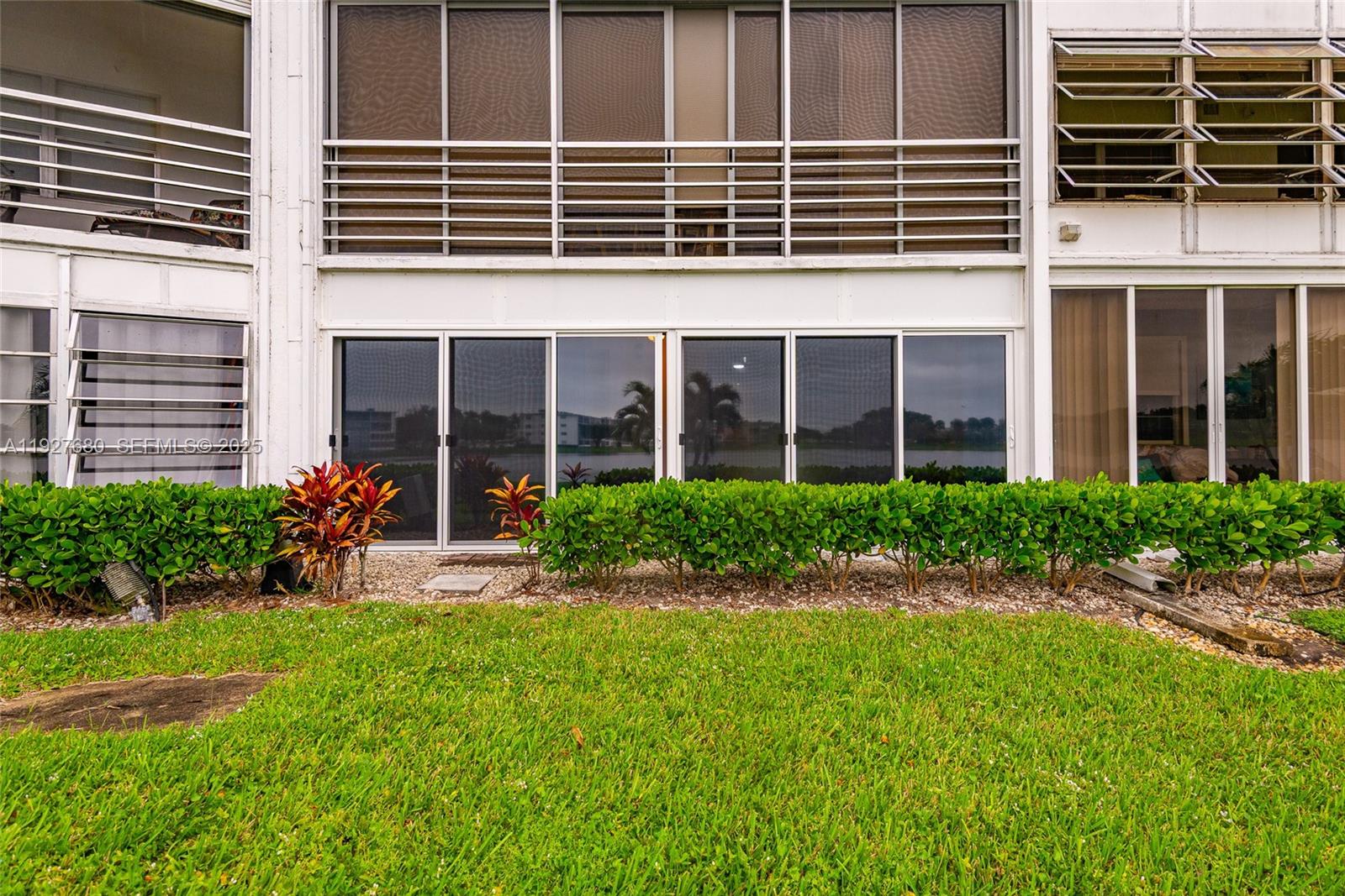1061 Exeter, Unit 1061D Boca Raton, FL 33434 - Photo 24 of 32 a view of a building with a garden