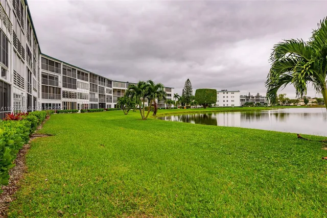 a view of a garden with a building in the background