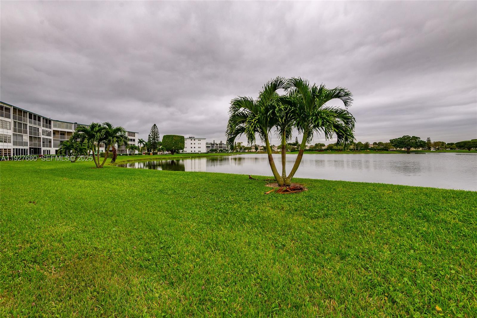 1061 Exeter, Unit 1061D Boca Raton, FL 33434 - Photo 27 of 32 a view of a garden with a building in the background