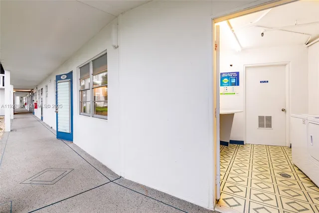 a room with a sink and a refrigerator