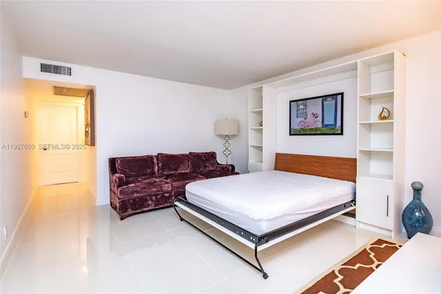 a bedroom with a bed and a couch