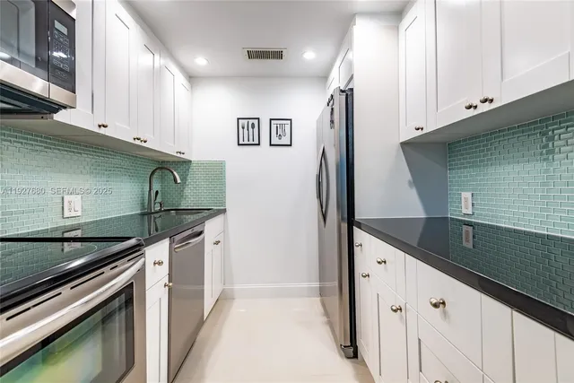 a kitchen with granite countertop a sink and cabinets