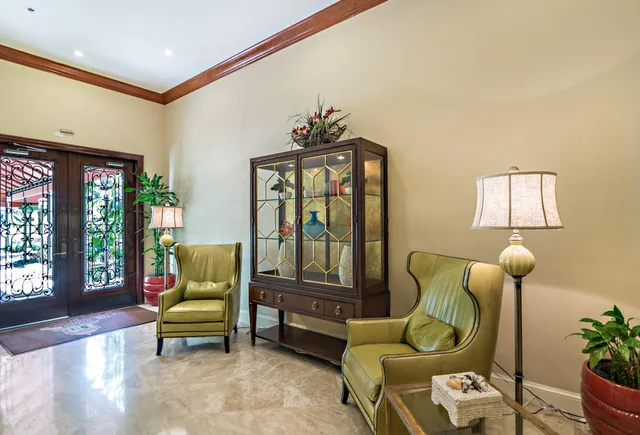 a living room with furniture flowerpot and wooden floor