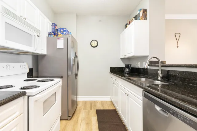 a kitchen with a sink stove and refrigerator