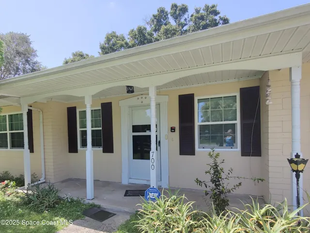 front view of a house with a potted plant