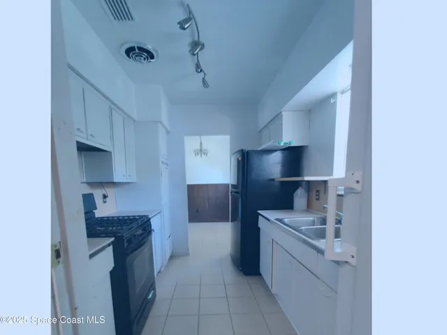 a kitchen with stainless steel appliances a sink stove and refrigerator