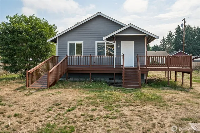 a view of a house with a yard and sitting area