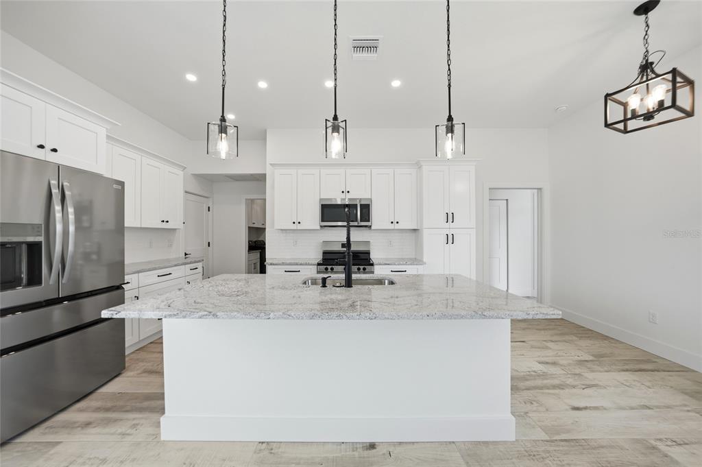 8846 Southwest Liverpool Road Arcadia, FL 34269 - Photo 11 of 49 a view of a kitchen with kitchen island a counter top space stainless steel appliances and cabinets