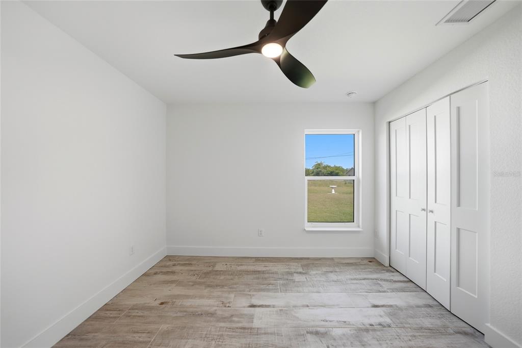 8846 Southwest Liverpool Road Arcadia, FL 34269 - Photo 18 of 49 wooden floor in an empty room with a window
