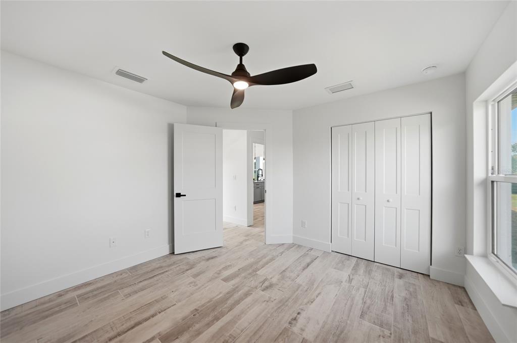 8846 Southwest Liverpool Road Arcadia, FL 34269 - Photo 20 of 49 a view of empty room with wooden floor and ceiling fan