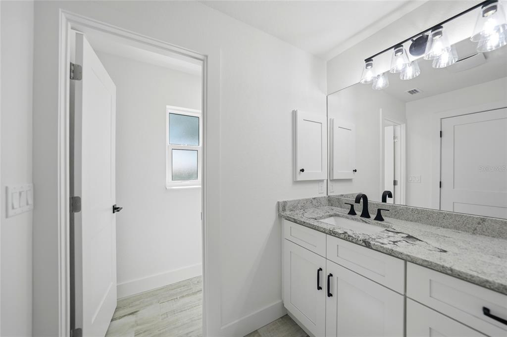8846 Southwest Liverpool Road Arcadia, FL 34269 - Photo 29 of 49 a bathroom with a granite countertop sink and a mirror