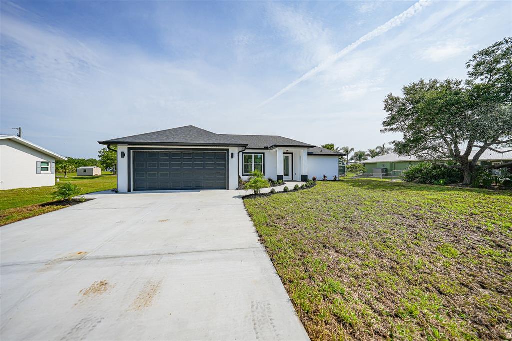 8846 Southwest Liverpool Road Arcadia, FL 34269 - Photo 36 of 49 a front view of a house with a yard and garage