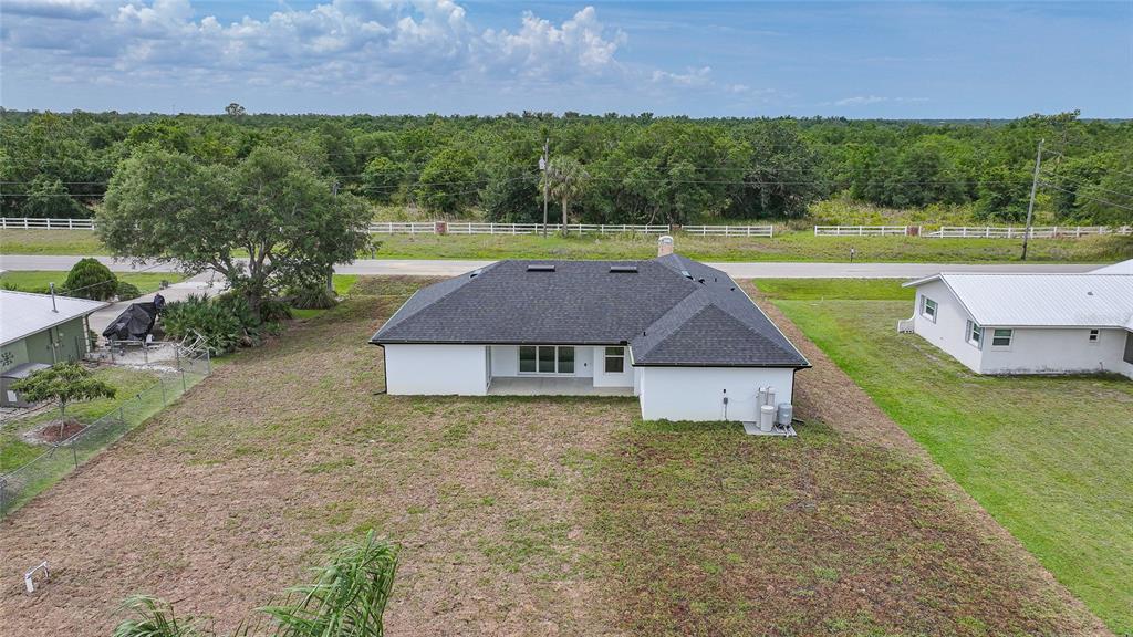 8846 Southwest Liverpool Road Arcadia, FL 34269 - Photo 42 of 49 a aerial view of a house with garden and a outdoor space
