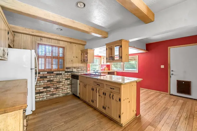 a kitchen with stainless steel appliances a sink and a stove
