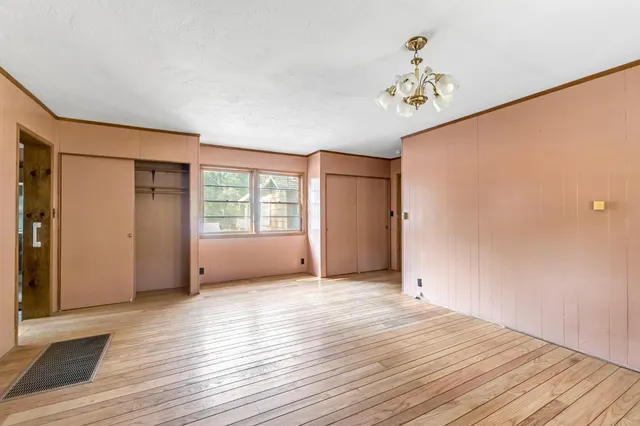 a bathroom with a bathtub a mirror and a shower