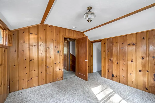 a view of a hallway with wooden walls