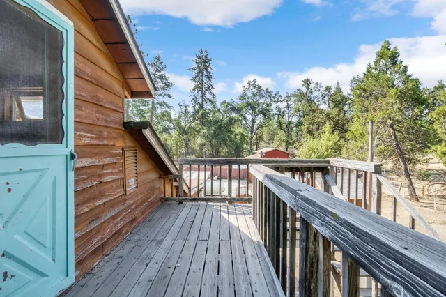 a view of a room with wooden floor and iron stairs
