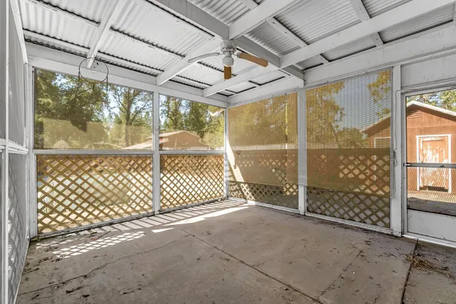 a view of a house with a small yard and wooden fence