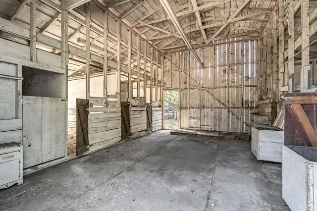 a view of a house with a yard and potted plants
