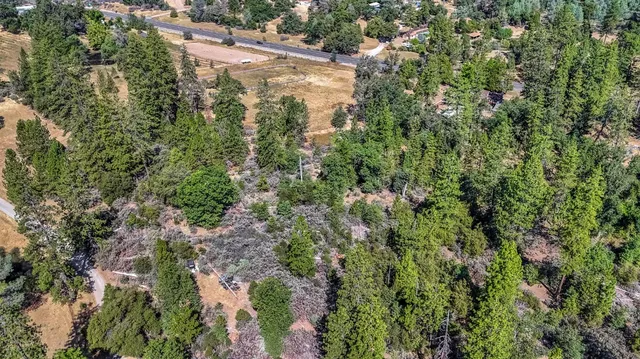 an aerial view of a house with a yard and garden