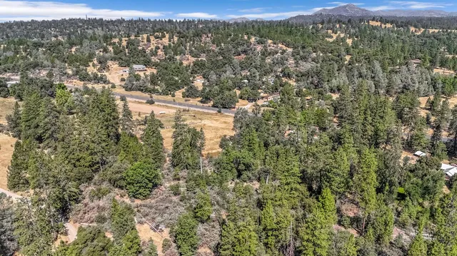 an aerial view of a house with a yard and garden