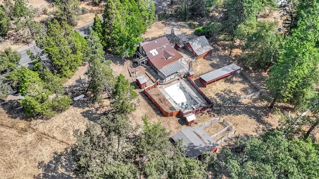 an aerial view of a house with a yard and balcony