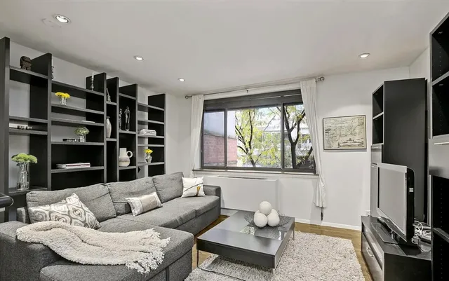 a living room with furniture cabinets and a flat screen tv