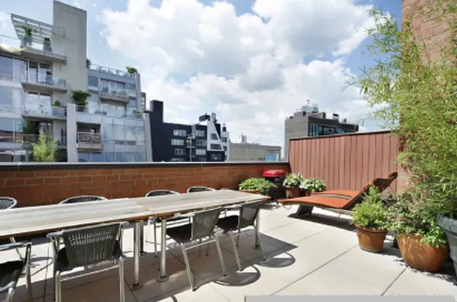 a outdoor sitting area with furniture and city view