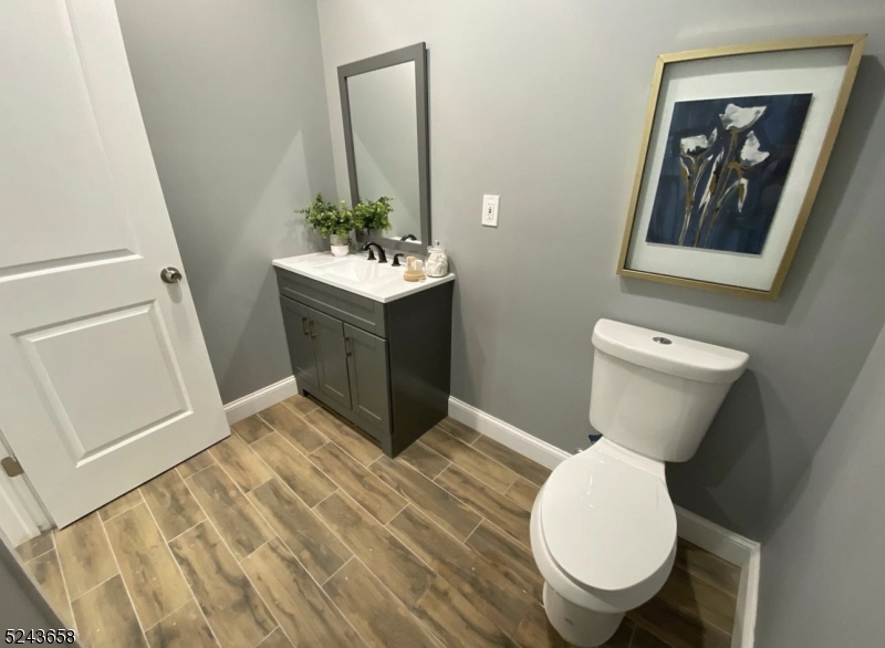 825 Allwood Road, Unit A Clifton, NJ 07012 - Photo 4 of 11 a bathroom with a toilet sink and mirror