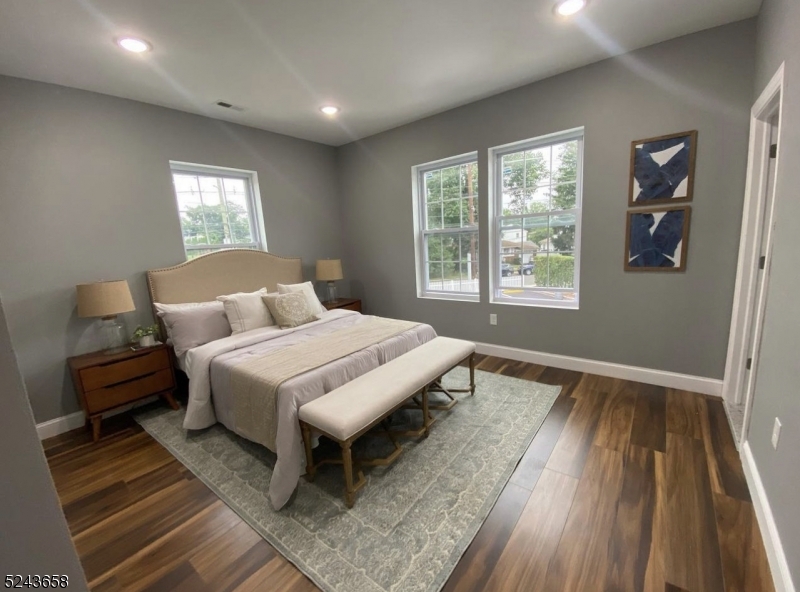 825 Allwood Road, Unit A Clifton, NJ 07012 - Photo 9 of 11 a bedroom with a bed and wooden floor