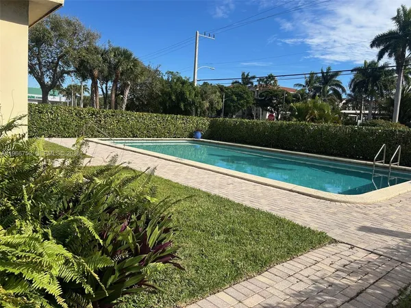 a view of a swimming pool with a yard