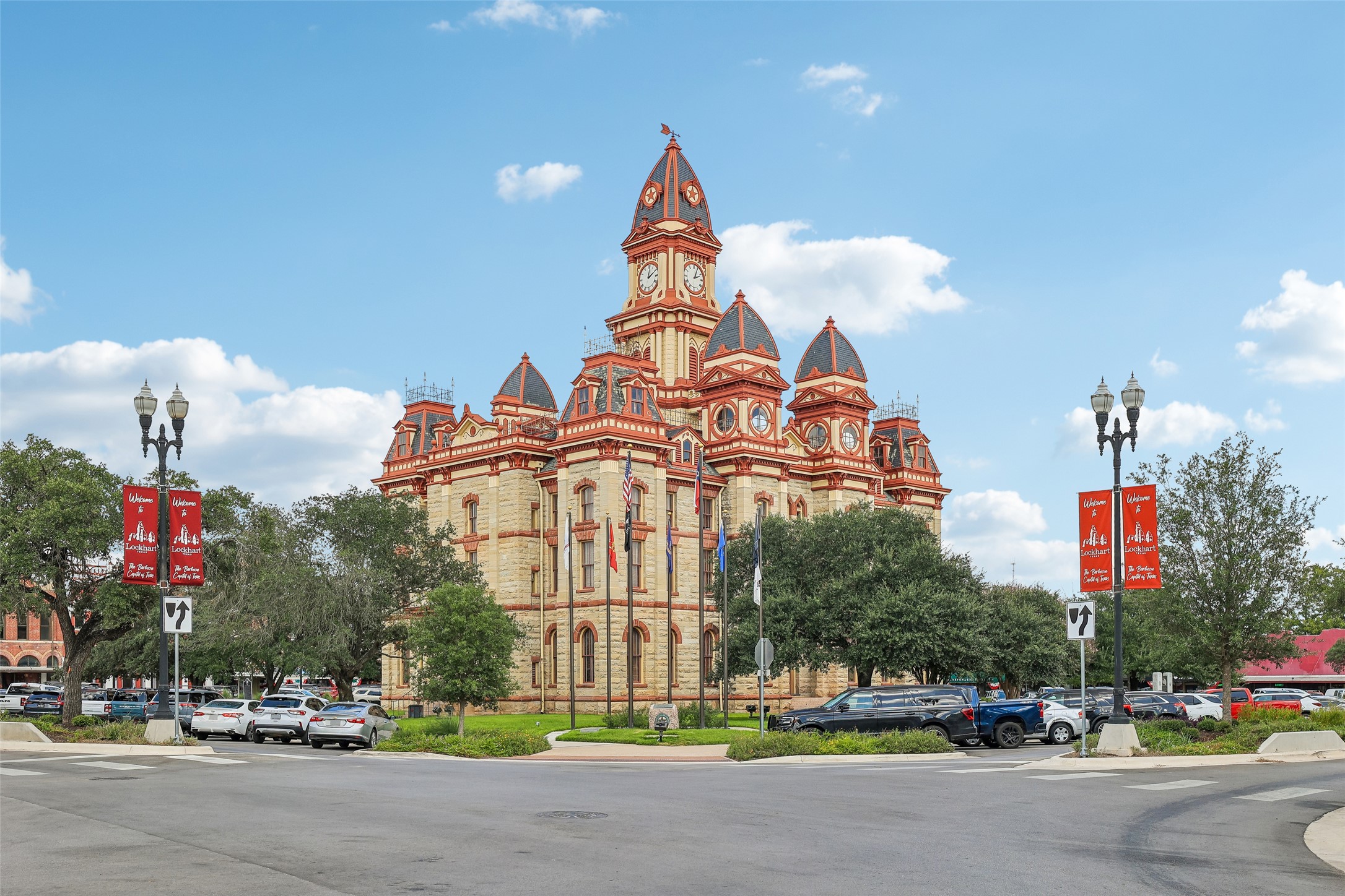 372 Old Lockhart Road Lockhart, TX 78644 - Photo 34 of 40 Ornate historic stone architecture stands prominently against a bright blue sky.