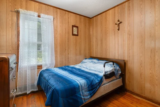 a bed sitting in a bedroom next to a bathroom