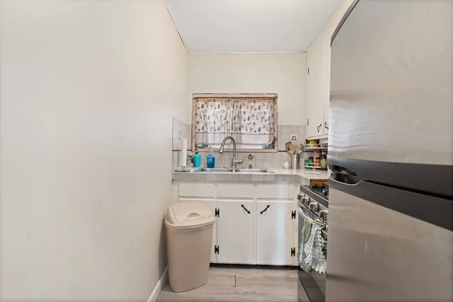 a kitchen with a sink a stove and cabinets