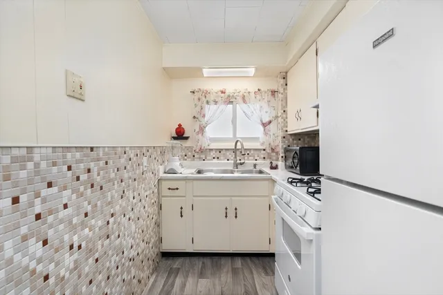 a kitchen with granite countertop a sink and a stove
