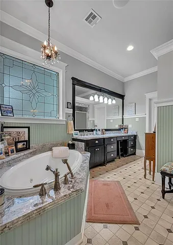 a large kitchen with a counter space a sink stainless steel appliances and cabinets