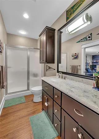 a bathroom with a granite countertop sink and a mirror