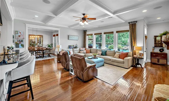 a living room with furniture or wooden floor and a large window