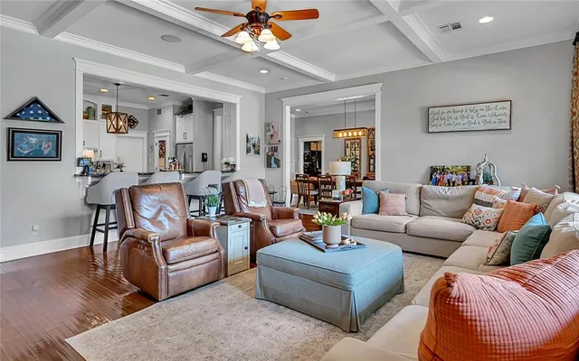 a living room with furniture and a chandelier