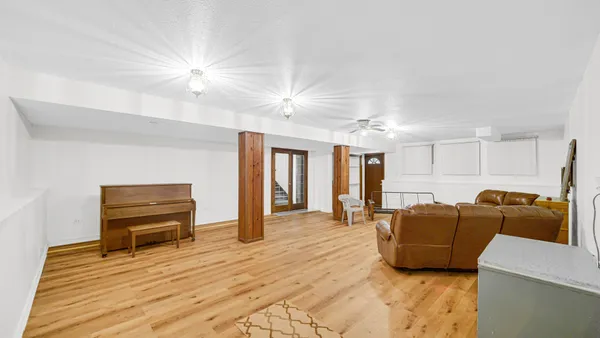 a living room with furniture and a dresser